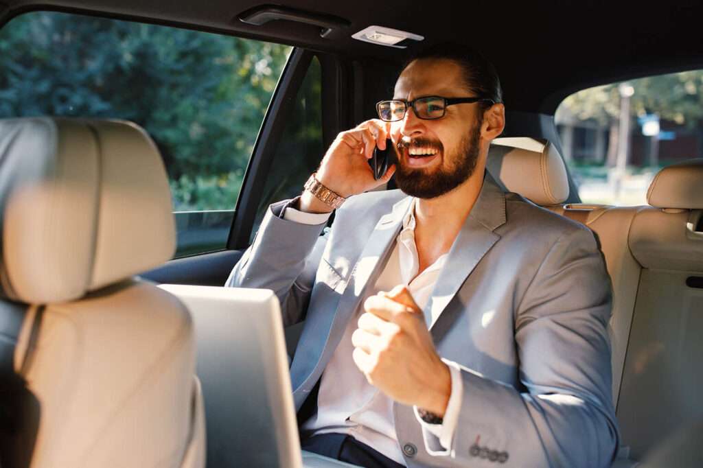 businessman talking on the phone in a taxi 2023 04 06 06 14 51 utc Riyadh Transport Services