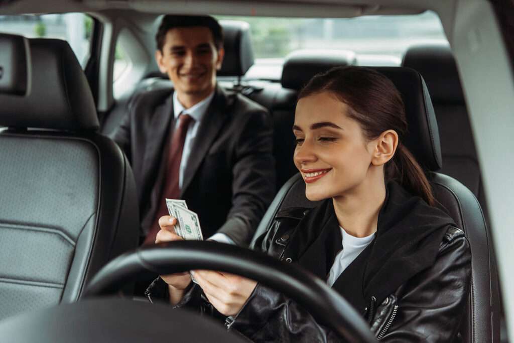 smiling taxi driver holding cash with businessman 2023 05 20 00 47 48 utc Riyadh Transport Services